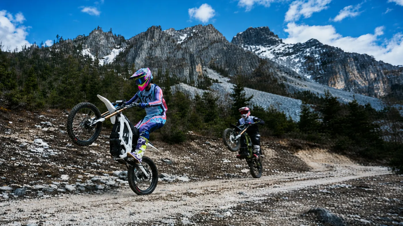 Rider lifting the front wheel of a Sur-Ron Light Bee 2 X on a mountain trail
